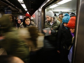 In this Tuesday, Feb. 5, 2013 photo, rush hour commuters wait as others leave a subway along the Lexington Avenue line in New York. The construction of the Second Avenue Subway on Manhattan's far East Side will open travel for millions and ease congestion. (AP Photo/Bebeto Matthews)