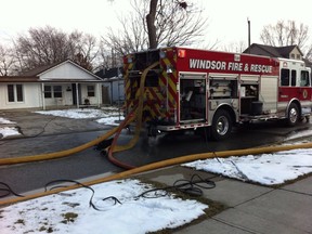 Firefighters on the scene of a house fire in the 900 block of Jos. Jannise Avenue in Windsor. (Jason Kryk/The Windsor Star)