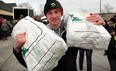 Essex District High School student Mitch Hudvagner shows his strength by carrying two sacks of potatoes from C.J. Bradley and Sons during United Communities Credit Union Farms to Food Banks program at United Communities Credit Union on Talbot Street in Essex, February 21, 2013. (NICK BRANCACCIO/The Windsor Star)