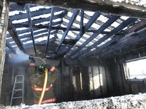 Firefighters with the Essex Fire and Rescue Service work on a house fire Thursday, Feb. 7, 2013, at a home in the 1500 block of Gore Road. The home which was under renovations suffered extensive damage.  (DAN JANISSE/The Windsor Star)