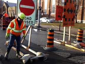 Manuel Claro of Coco Paving places barricades and road closure signs on Goyeau Street  at Park Street for the Tunnel Plaza project.  As of Monday, Feb. 11, 2013, motorists will be using Wyandotte Street East to access the Windsor Detroit Tunnel.  (NICK BRANCACCIO/The Windsor Star).