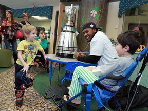 The Toronto Argonauts Walter Spencer talks to Elliott Fitzgerald, left, and Joel Fejes-Vickerd, right, about the Grey Cup at Windsor Regional Hospital in Windsor on Tuesday, February 5, 2013.  (TYLER BROWNBRIDGE / The Windsor Star)