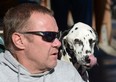 Rick Heltebrake, the man who called police informing them that fugitive Christopher Dorner had hijacked his car, talks to the media with his dog Suni about the ordeal in Angelus Oaks, California, February 13, 2013. Suspected cop killer Dorner is believed to have been killed in a shoot-out at a cabin in the San Bernardino Mountains. AFP PHOTO / JOE KLAMAR