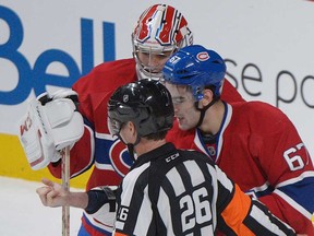 Montreal Canadiens' Max Pacioretty, right, shows his arm to a referee following an incident with Toronto Maple Leafs' Mikhail Grabovski as Canadiens' goaltender Carey Price looks on during third period NHL hockey action in Montreal, Saturday, February 9, 2013. Pacioretty says he got a tetanus shot after he was allegedly bitten by Grabovski.(THE CANADIAN PRESS /Graham Hughes)