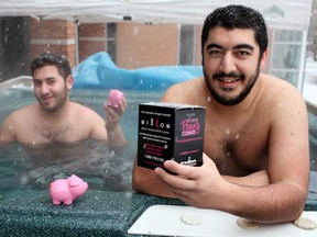 Josh Harendorf, 20, left, and Mamoon Kattan, 20, both members of the Sigma Chi fraternity, sit in a hot tub outside the CAW Centre to try to raise money for Willow Breast Cancer Support Canada, Monday, February 4, 2013.  Harendorf and Kattan are part of a group of 19 men who will be sitting in the tub for 100 hours straight in rotating shifts.  (DAX MELMER/The Windsor Star)