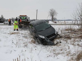 A driver with County Towing removes a Ford Fiesta from a field in the 7300 block of Howard Avenue in Amherstburg, Ontario on February 5, 2013 following a two-vehicle accident.  Amherstburg police, Windsor-Essex EMS paramedics were attended.  At least one person was treated for injuries at the scene.   Amherstburg police are investigating the accident and closed the road for a short period of time. (JASON KRYK/The Windsor Star)