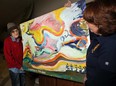 In this file photo, resident Ed Learmonth, left, moves one of his paintings with help of his sister Eileen Learmonth at IRIS House on Ouellette Avenue where residents and staff can breathe a little easier after hearing no beds will be lost, Wednesday February 20, 2013. (NICK BRANCACCIO/The Windsor Star)