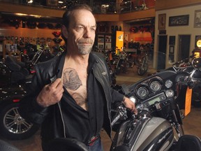 Joe DuBois, who works at Kane’s Harley-Davidson, was having a tattoo done at Smilin’ Buddha when the winner of the $30-million lottery ticket came in and said he couldn’t stay for his appointment, he had just won the lottery. (Christina Ryan/Calgary Herald)