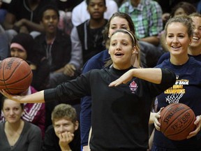 University of Windsor Lancers Jocelyn LaRocque, front, Anna Mullins and Kim Moroun, right, compete against  J.L. Forster Spartans during a friendly basketball shooting challenge after it was announced Forster high school was the first school to donate $500 to the 2013 International Children's Games Adopt an Athlete program Thursday February 14, 2013.  (NICK BRANCACCIO/The Windsor Star).