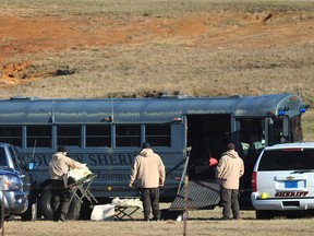 Law enforcement personnel load provisions into a bus during the third day of a hostage crisis involving a 5-year-old boy, in Midland City, Ala, Thursday, Jan 31, 2013. A standoff in rural Alabama went into a second full day Thursday as police surrounded an underground bunker where a retired truck driver was holding a 5-year-old hostage he grabbed off a school bus after shooting the driver dead. The bus driver, Charles Albert Poland Jr., 66, was hailed by locals as a hero who gave his life to protect the 21 students aboard the bus. (AP Photo/The Dothan Eagle, Jay Hare)