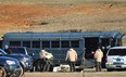 Law enforcement personnel load provisions into a bus during the third day of a hostage crisis involving a 5-year-old boy, in Midland City, Ala, Thursday, Jan 31, 2013. A standoff in rural Alabama went into a second full day Thursday as police surrounded an underground bunker where a retired truck driver was holding a 5-year-old hostage he grabbed off a school bus after shooting the driver dead. The bus driver, Charles Albert Poland Jr., 66, was hailed by locals as a hero who gave his life to protect the 21 students aboard the bus. (AP Photo/The Dothan Eagle, Jay Hare)