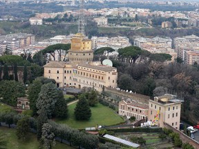 A view of the Mater Ecclesiae Monastery, right, next to the Tower of San Giovanni, inside the Vatican State where Pope Benedict XVI is expected to live after he resigns, on Tuesday, Feb. 12, 2013. For months, construction crews have been renovating a four-story building attached to a monastery on the northern edge of the Vatican gardens where nuns would live for a few years at a time in cloister. Only a handful of Vatican officials knew it would one day be Pope Benedict XVI's retirement home. On Tuesday, construction materials littered the front lawn of the house and plastic tubing snaked down from the top floor to a dump truck as the restoration deadline became ever more critical following Benedict's stunning announcement that he would resign Feb. 28 and live his remaining days in prayer. (AP Photo/Alessandra Tarantino)
