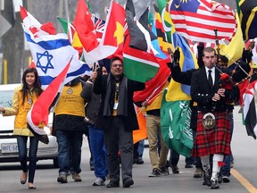 A bagpiper joins Enrique Chacon, centre, of the International Student Centre, during a parade of flags, part of University of Windsor Celebration of Nations event Thursday February 14, 2013.  (NICK BRANCACCIO/The Windsor Star).