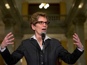 In this file photo, incoming Ontario premier Kathleen Wynne speaks to the media at Queen's Park before her first caucus meeting in Toronto on Tuesday, January 29, 2013. (THE CANADIAN PRESS/Nathan Denette)