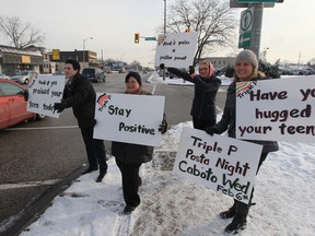 From left, Dusko Miljevic, Tammy Drazilov, Kaylee Brown, and Geralyn LeBlanc take part in the "Honk if you're a positive parent Triple P" postive parenting program information event on Tecumseh Road east at Parent Avenue in Windsor, Ontario on February 5, 2013. The community partnership includes: Children First Family Respite Services, John McGivney Children's Centre, Maryvale Adolescent and Family Services, The Inn of Windsor, The Windsor-Essex Children's Centre (Windsor Regional Hospital) and the Windsor-Essex County Health Unit. The information event goes hand-in-hand with the Triple P monthly pasta night on February 6, 2013 at the Caboto Club. (JASON KRYK/The Windsor Star)