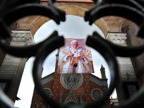 A poster showing Pope Benedict XVI portrait is hanged in front of St. Anthony of Padua Church reading "Thank you holy father" on February 27, 2013 in Istanbul. Pope Benedict XVI will hold the last audience of his pontificate in St Peter's Square on Wednesday on the eve of his historic resignation as leader of the world's 1.2 billion Catholics. AFP PHOTO/BULENT KILICBULENT