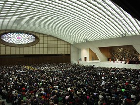 Faithful attend Pope Benedict XVI's weekly audience at the Paul VI Hall on February 13, 2013 in Vatican City, Vatican. The Pontiff will hold his last weekly public audience on February 27 at St Peter's Square after announcing his resignation earlier this week. (Photo by Franco Origlia/Getty Images)