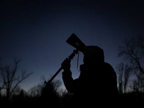 Dan Taylor, a member of the Windsor Centre of the Royal Astronomical Society of Canada, looks at the night sky through binoculars while at Point Pelee National Park, Saturday, February 9, 2013.  Once a month, on a Saturday closest to the new moon, the park remains open until midnight to celebrate it's 2006 designation as a Dark Sky Preserve.  (DAX MELMER/The Windsor Star)