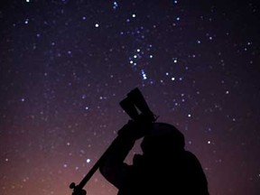 Dan Taylor, a member of the Windsor Centre of the Royal Astronomical Society of Canada, looks at the night sky through binoculars while at Point Pelee National Park, Saturday, February 9, 2013.   (DAX MELMER/The Windsor Star)