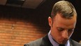 South African Olympic sprinter Oscar Pistorius appears on February 21, 2013 at the Magistrate Court in Pretoria. Pistorius battled to secure bail as he appeared on charges of murdering his model girlfriend Reeva Steenkamp on February 14, Valentine's Day. South African prosecutors will argue that Pistorius is guilty of premeditated murder in Steenkamp's death, a charge which could carry a life sentence. South African police said today they have not yet decided whether to drop the lead detective investigating murder charges against Oscar Pistorius, after it emerged that he himself is facing seven attempted murder charges.AFP PHOTO / ALEXANDER JOE