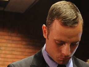 South African Olympic sprinter Oscar Pistorius appears on February 21, 2013 at the Magistrate Court in Pretoria. Pistorius battled to secure bail as he appeared on charges of murdering his model girlfriend Reeva Steenkamp on February 14, Valentine's Day. South African prosecutors will argue that Pistorius is guilty of premeditated murder in Steenkamp's death, a charge which could carry a life sentence. South African police said today they have not yet decided whether to drop the lead detective investigating murder charges against Oscar Pistorius, after it emerged that he himself is facing seven attempted murder charges.AFP PHOTO / ALEXANDER JOE