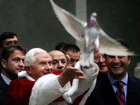 Pope Benedict XVI frees a dove upon his arrival at Istanbul's Holy Spirit Cathedral in Istanbul, 01December 2006. The Pope released four white doves, symbols of peace, into the air outside the Cathedral of the Holy Spirit before celebrating the second and final mass of his busy four-day visit to Turkey. AFP PHOTO / MUSTAFA OZER