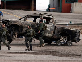 A burned-out pickup truck belonging to ex-Los Angeles police officer Christopher Dorner is towed after it was discovered in Big Bear, Calif, Thursday, Feb. 7, 2013. The ex-Los Angeles police officer who authorities say went on a killing spree to punish those he blamed for his firing killed three people, set off a manhunt that stretched across three states and into Mexico, and stirred fear throughout the region. (AP Photo/Jae C. Hong)