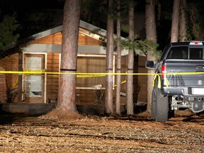 Yellow crime-scene tape blocks off the front of a home in Heber Springs, Ark., where country singer Mindy McCready was found dead in an apparent suicide on Sunday, Feb. 17, 2013. She was 37. (AP Photo/Jeannie Nuss)