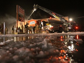 Tecumseh firefighters work on a fire at the Tecumseh Roadhouse restaurant on County Rd. east of Lauzon Rd. (DAN JANISSE/The Windsor Star)