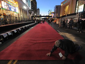 Workers roll out red carpets for the Oscars, the 85th Academy Awards, outside the Dolby Theatre on Hollywood Boulevard in Hollywood, California, on February 20, 2013. The ceremony is scheduled for February 24, 2013.   AFP PHOTO/JOE KLAMARJOE KLAMAR/AFP/Getty Images