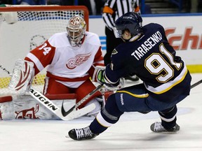 St. Louis Blues' Vladimir Tarasenko, of Russia, shoots just wide of Detroit Red Wings goalie Petr Mrazek, left, of the Czech Republic, during the second period of an NHL hockey game Thursday, Feb. 7, 2013, in St. Louis. (AP Photo/Jeff Roberson)