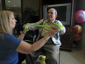 Registered physiotherapist Merle Duchesne, left, works with Louie Baioff, a resident at Seasons Royal Oak Village Retirement Community in LaSalle, Ontario, on February 20, 2013.   (JASON KRYK/The Windsor Star)