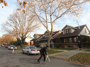 Windsor police investigate Friday, Nov. 25, 2011, a murder scene at 1462 Albert Rd. in Windsor, Ont. A man was stabbed to death last night. .(DAN JANISSE/The Windsor Star)