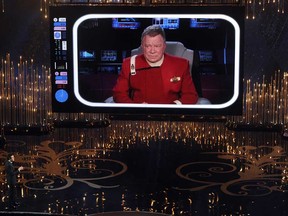 Host Seth MacFarlane talks to actor William Shatner on the video screen during the Oscars held at the Dolby Theatre on February 24, 2013 in Hollywood.  (Photo by Kevin Winter/Getty Images)