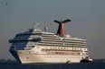 In this Feb. 14, 2013 file photo the cruise ship Carnival Triumph is towed into Mobile Bay near Dauphin Island, Ala., Thursday, Feb. 14, 2013. A leak in a fuel oil return line caused the engine-room fire that disabled a Carnival cruise ship at sea, leaving 4,200 people without power or working toilets for five days, a Coast Guard official said Monday, Feb. 18, 2013. (AP Photo/Dave Martin, File)