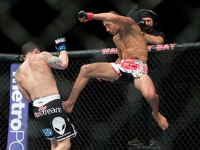 Jose Aldo, of Rio de Janeiro, kicks Frankie Edgar during their UFC 156 featherweight mixed martial arts title match, Saturday, Feb. 2, 2013 at The Mandalay Bay Resort & Casino in Las Vegas. Aldo won by unanimous decision. (AP Photo/Eric Jamison)