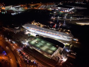 The crippled cruise liner Carnival Triumph limps into port guided by tug boats February 14, 2013 in Mobile, Alabama. An engine fire on February 10 left the ship and its 4,000 passengers without power and with scarce food. While people onboard reported toilets that wouldn't work, the ship was restocked with food during the days it was being towed through the Gulf of Mexico. According to reports, a few dozen people awaited the ship's arrival in Mobile, covered live by cable news network CNN. (Photo by Jeff Gammons/Getty Images)