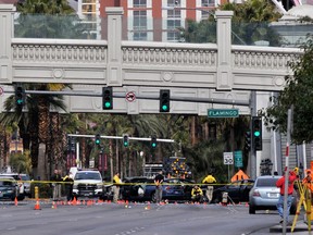 Las Vegas Metro officers investigate the site of what is being described as a gun battle between shooters in vehicles along the Las Vegas Strip on February 21, 2013 in Las Vegas, Nevada. According to reports gunshots were fired between black SUV at a Maserati, causing the Maserati to crash into a taxi, that burst into flames. Five vehicles were involved in the subsequent crash with the Maserati driver and two people in the taxi being killed. (Photo by David Becker/Getty Images)