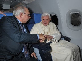 Rome Bureau Chief Victor Simpson, left, shakes hands with Pope Benedict XVI during the flight from Beirut to Rome, Sept. 16, 2012. Simpson has chronicled four papacies in 35 years covering the Holy See. A Vatican institution in his own right, Simpson has had a unique vantage point on history, enjoying the ear of Vatican insiders and chatting with the pope himself on foreign pilgrimages. (AP Photo/L'Osservatore Romano, ho)