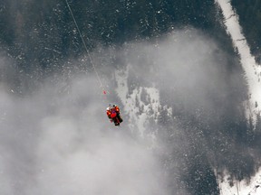 United States’ Lindsey Vonn is airlifted by an helicopter after crashing during the women's super-G course, at the Alpine skiing world championships in Schladming, Austria, Tuesday, Feb.5, 2013. (AP Photo/Luca Bruno)