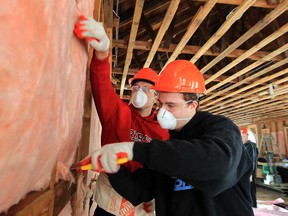 St. Joseph Catholic high school Grade 12 students Nick Iorio, right, and Matt Glasmann volunteer during renovations on the new Harmony in Action recreation centre in Windsor, Ont on Thursday, Feb. 7, 2013. (JASON KRYK/The Windsor Star)