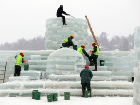 Volunteer Jeff Branch, top, and inmates from the Moriah Shock Incarceration Correctional Facility, work on the Saranac Lake Winter Carnival ice palace on Monday, Jan. 28, 2013, in Saranac Lake, N.Y. (AP Photo/Mike Groll)