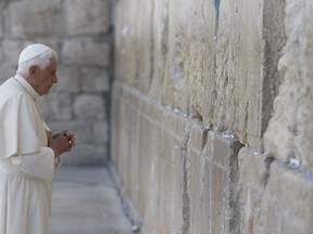A file picture taken on May 12, 2009 shows Pope Benedict XVI praying at the Western Wall in Jerusalem's Old City. Pope Benedict XVI announced on February 11, 2013 he will resign on February 28 because his age prevented him from carrying out his duties, an unprecedented move in the modern history of the Catholic Church. AFP PHOTO/POOL/RONEN ZVULUN