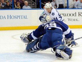Toronto's Mikhail Grabovski, right, scores a goal against Tampa Bay goalie Anders Lindback Tuesday in Tampa, Fla. (AP Photo/Brian Blanco)