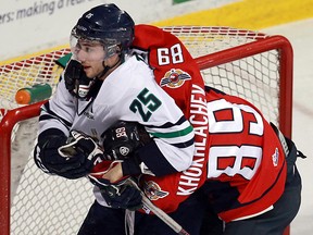 Windsor's Alex Khokhlachev, right, is in a headlock at the hands of Plymouth's Vincent Trocheck at the WFCU Centre. (TYLER BROWNBRIDGE/The Windsor Star)