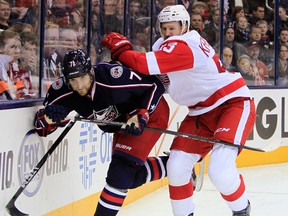 Detroit's Niklas Kronwall, right, checks Nick Foligno of the Blue Jackets in Columbus. (AP Photo/Jay LaPrete)