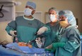 File photo of  Dr. Yigang Luo, left, and his assistant surgical nurses in the operating room at Hotel-Dieu Grace hospital in 2006. (Windsor Star files)