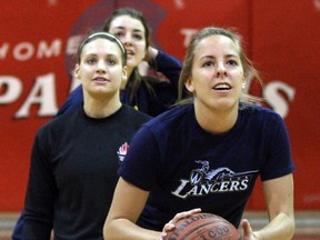 University of Windsor basketball players Kim Moroun, right, and Jocelyn LaRocque compete against the Forster Spartans in a friendly basketball shooting challenge, (NICK BRANCACCIO/The Windsor Star)