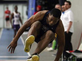 The University of Windsor's Arren Young competes in the men's triple jump at the OUA track and field meet at the St. Denis Centre. (TYLER BROWNBRIDGE/The Windsor Star)