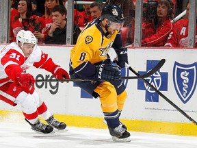 Nashville's Kevin Klein, right, is checked by Detroit's Valtteri Filppula Saturday at Joe Louis Arena. (Photo by Gregory Shamus/Getty Images)